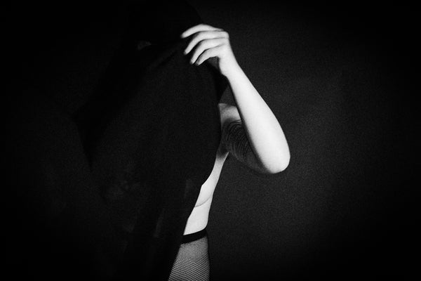 a black and white photo of a woman wearing a tie