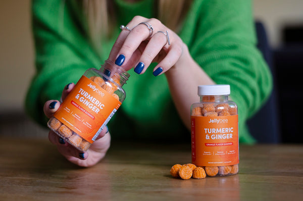 person holding orange labeled bottle