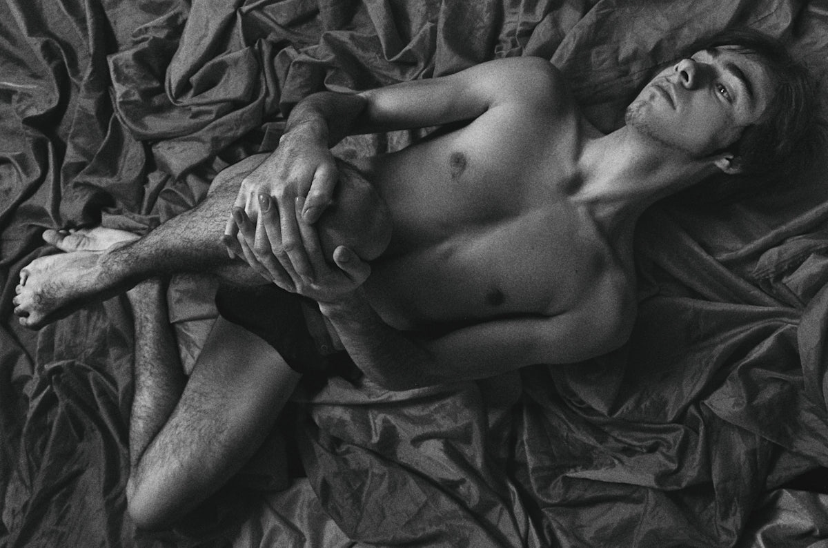 a person lying next to a baby