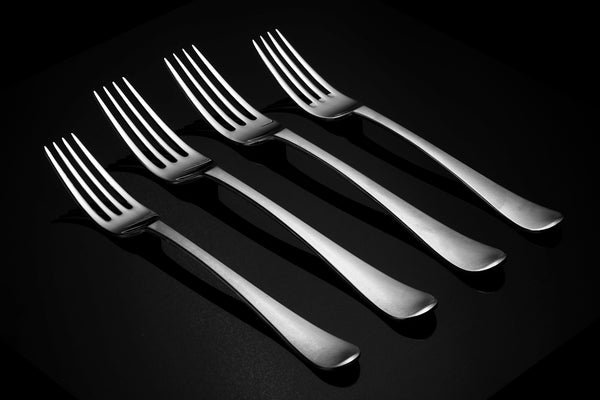 a set of four forks sitting next to each other