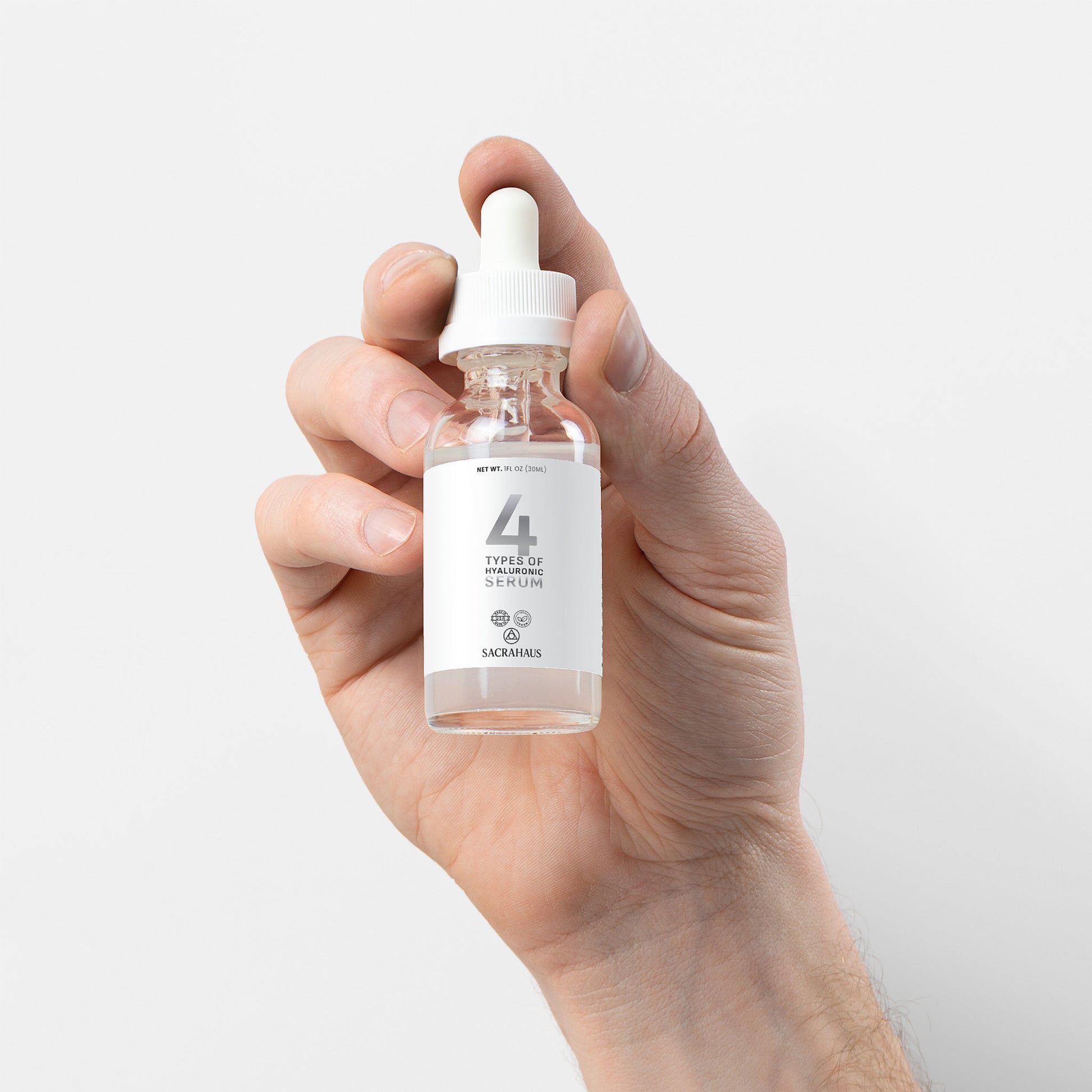 SACRAHAUS vegan hyaluronic acid serum in a dropper bottle held in hand for skincare routine