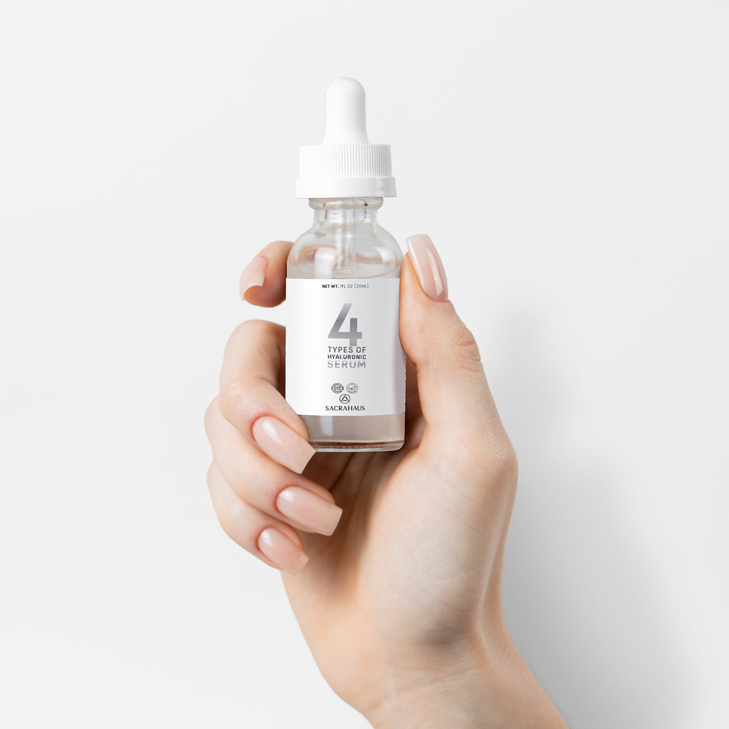 SACRAHAUS vegan hyaluronic acid serum in a dropper bottle held in a hand for facial hydration