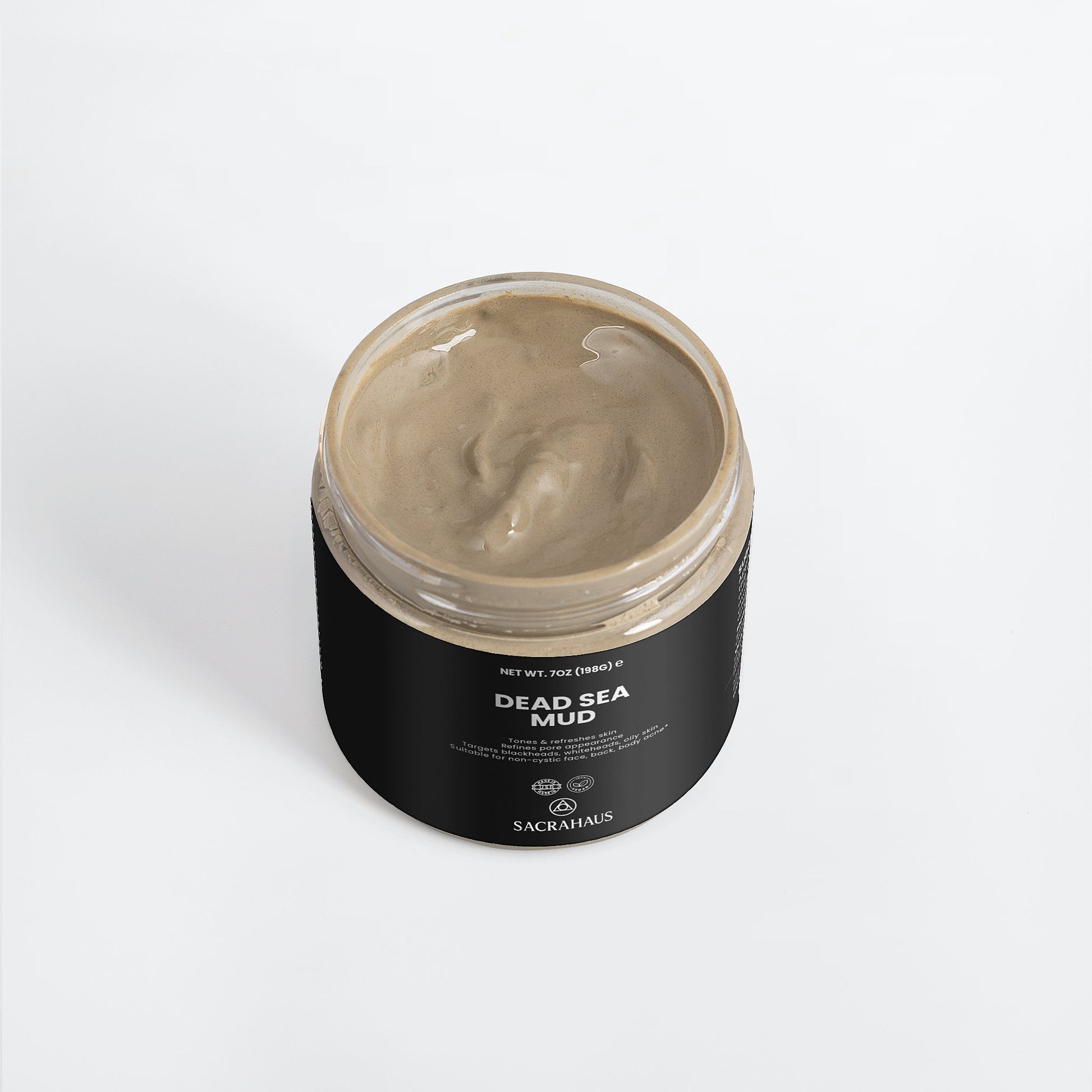 SACRAHAUS Dead Sea mud mask in an open jar showcasing its rich, creamy texture for skin care
