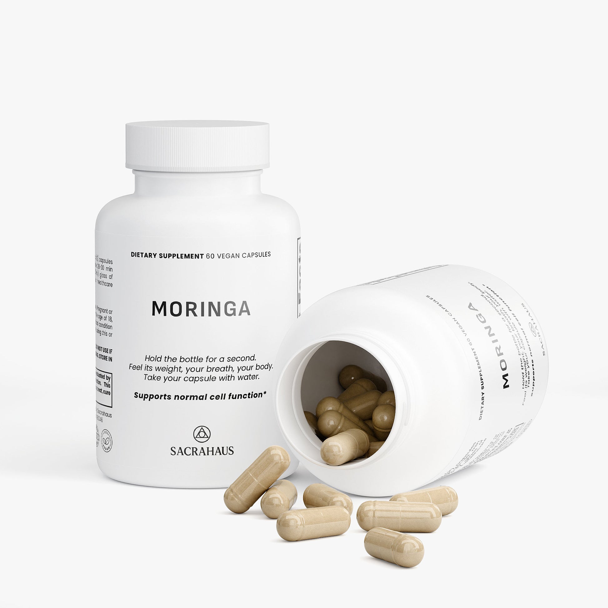 SACRAHAUS organic moringa capsules in a bottle with some capsules spilled out, supporting normal cell function