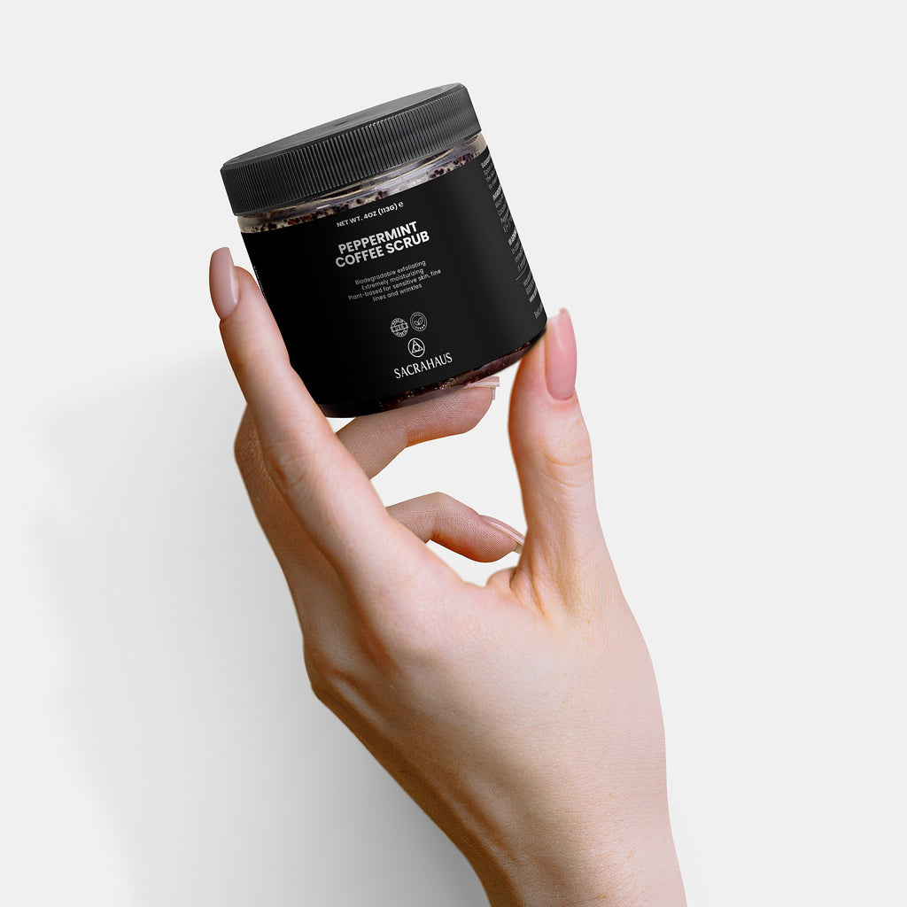 SACRAHAUS peppermint coffee scrub for sensitive skin in a hand-held jar with a sleek design