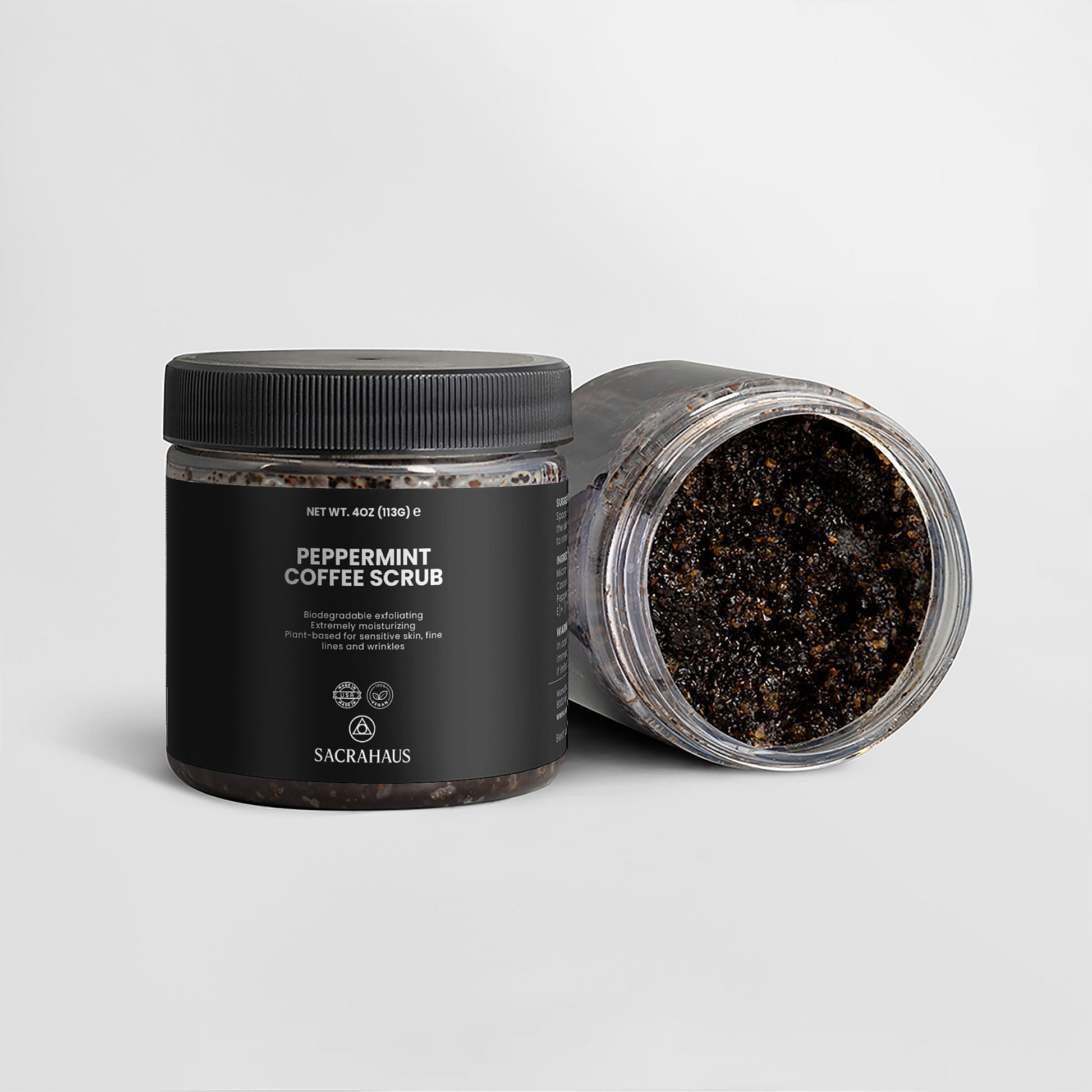 SACRAHAUS Peppermint Coffee Scrub for Sensitive Skin in a black jar with opened lid and visible scrub texture