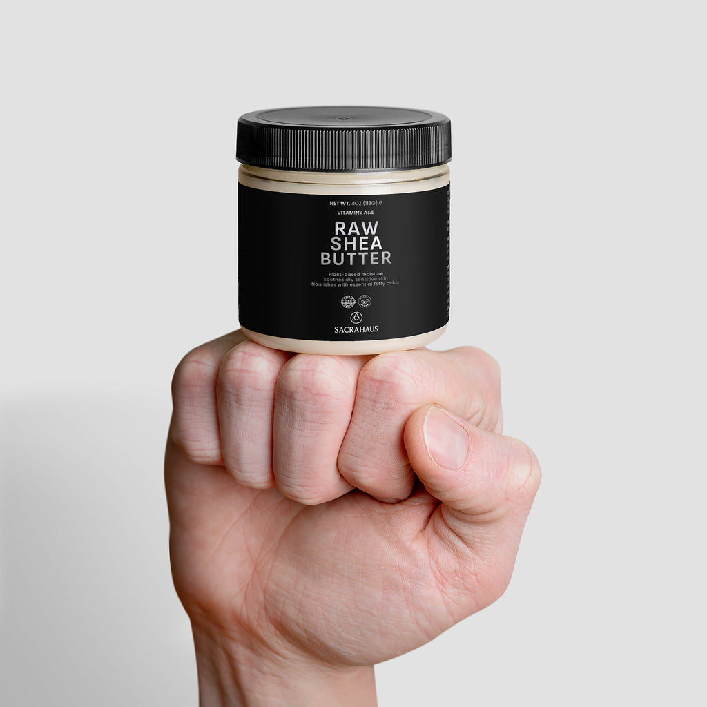 SACRAHAUS Raw Shea Butter for Skin in a jar held in a hand, ideal for moisturizing and nourishment