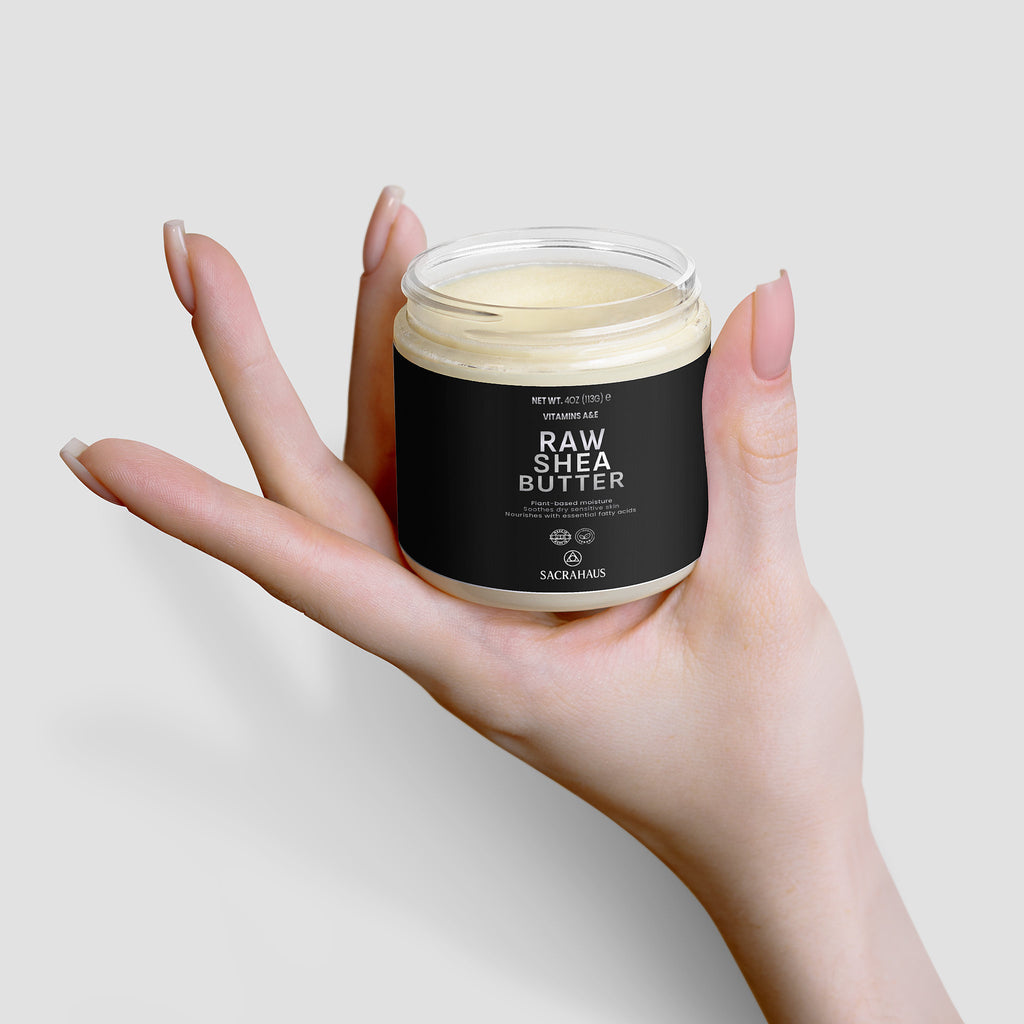SACRAHAUS Raw Shea Butter for skin in a hand, showcasing its rich and creamy texture.