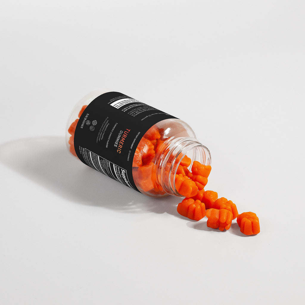 SACRAHAUS turmeric gummies for inflammation in an open bottle with gummies spilling out