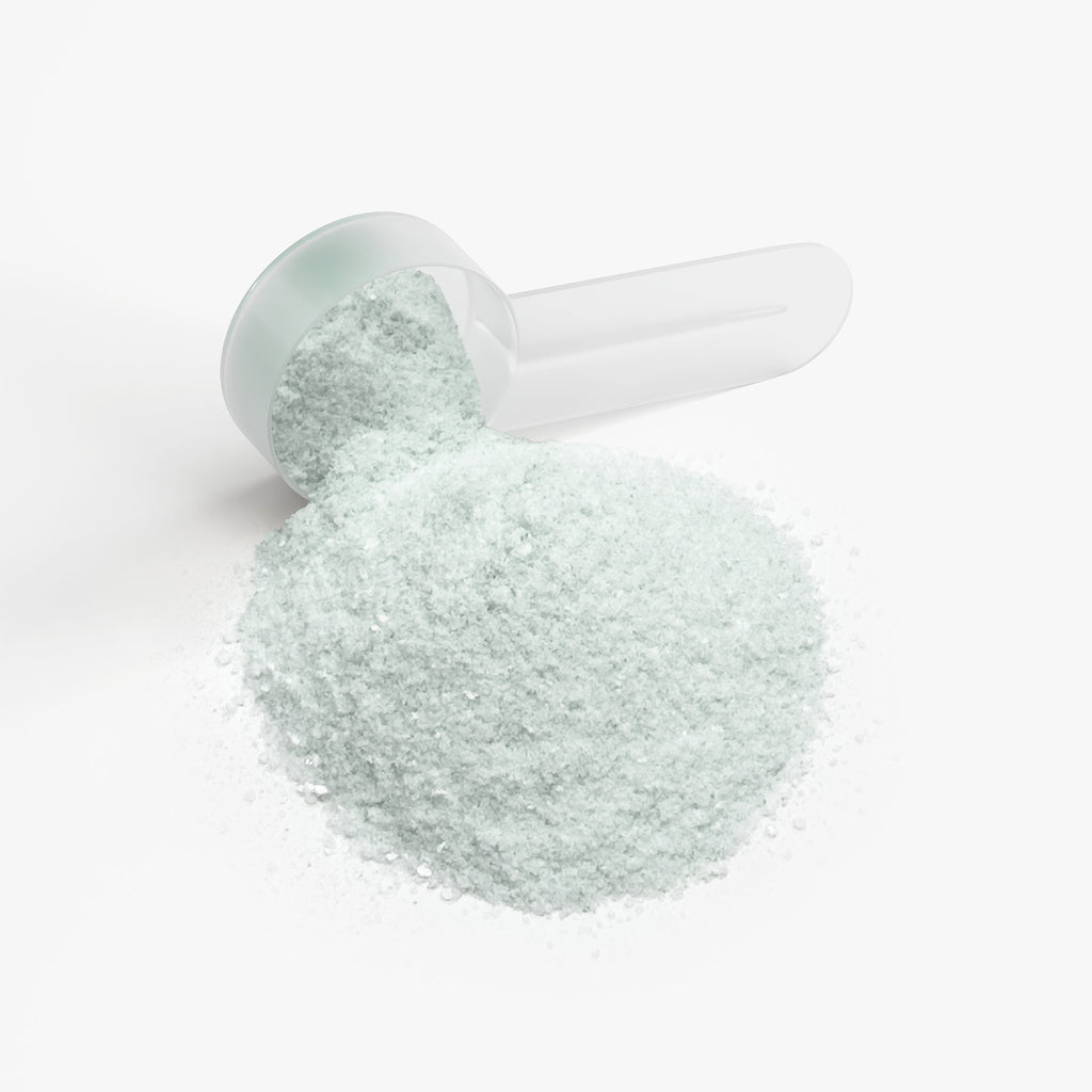SACRAHAUS vegan energy powder in a clear scoop, ideal for pre-workout energy boost