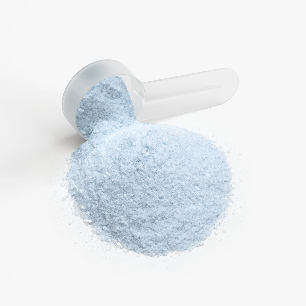 SACRAHAUS vegan energy powder cotton candy in a clear scoop for energizing pre-workout boost