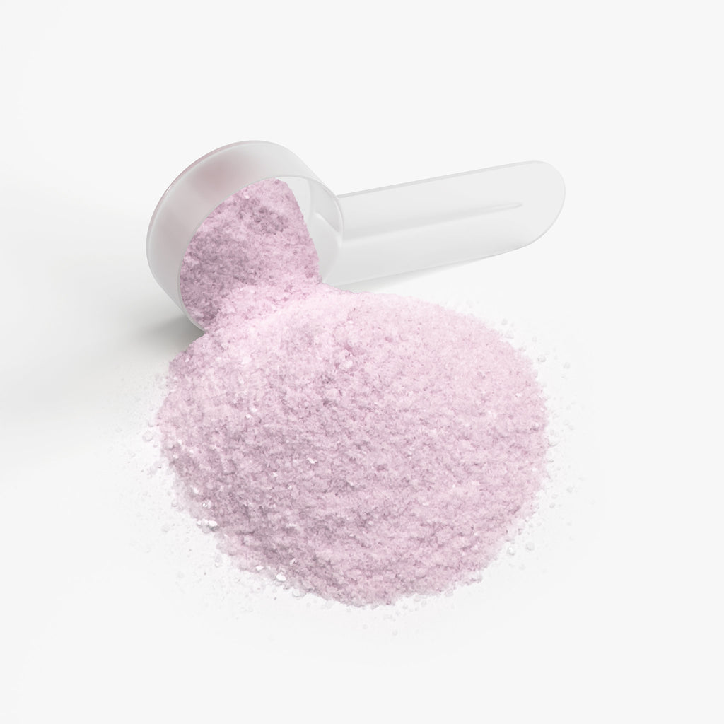 SACRAHAUS vegan energy powder in pink color displayed with a measuring scoop on a white background