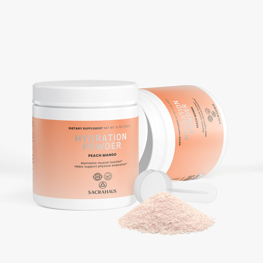 SACRAHAUS vegan hydration powder peach mango in a container with a scoop and powder next to it