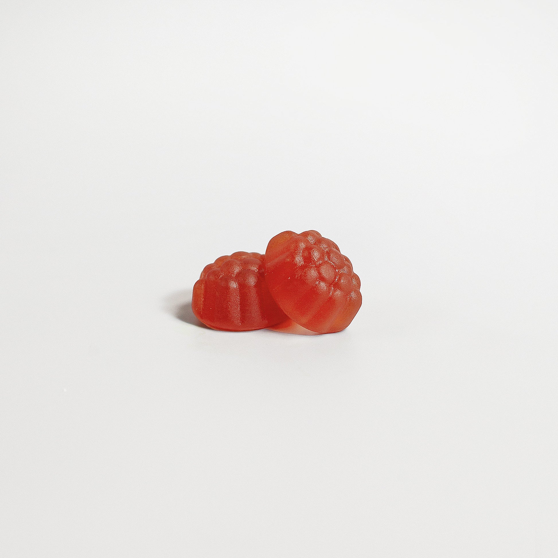 SACRAHAUS vegan sleep gummies red fruit shaped specialty supplements on white background